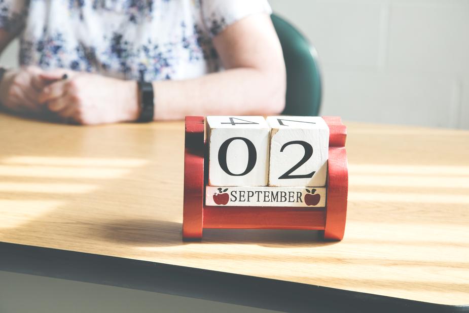 Desk of a teacher with a block calendar on it