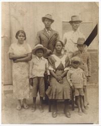 Sepia photo of an African American family in formal clothing