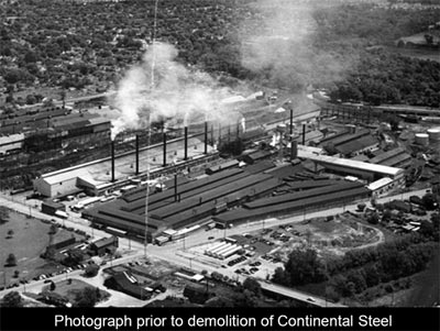 Black and White overhead photo of a large building with the text continental steel prior to demolition